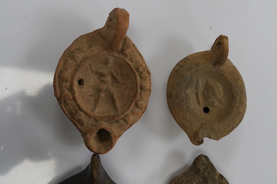 Six late Roman pottery lamps, three decorated with figures, including one with Christ in Majesty, and one decorated with the Chi Rho. Condition - fair to good.